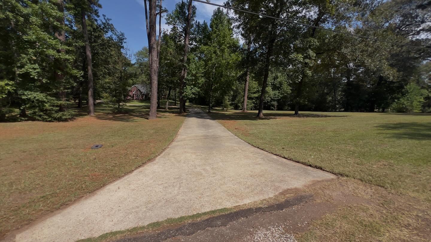 Country driveway with maintained lawn
